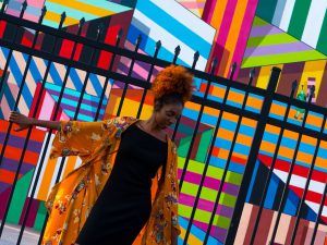 woman standing in front of black gate